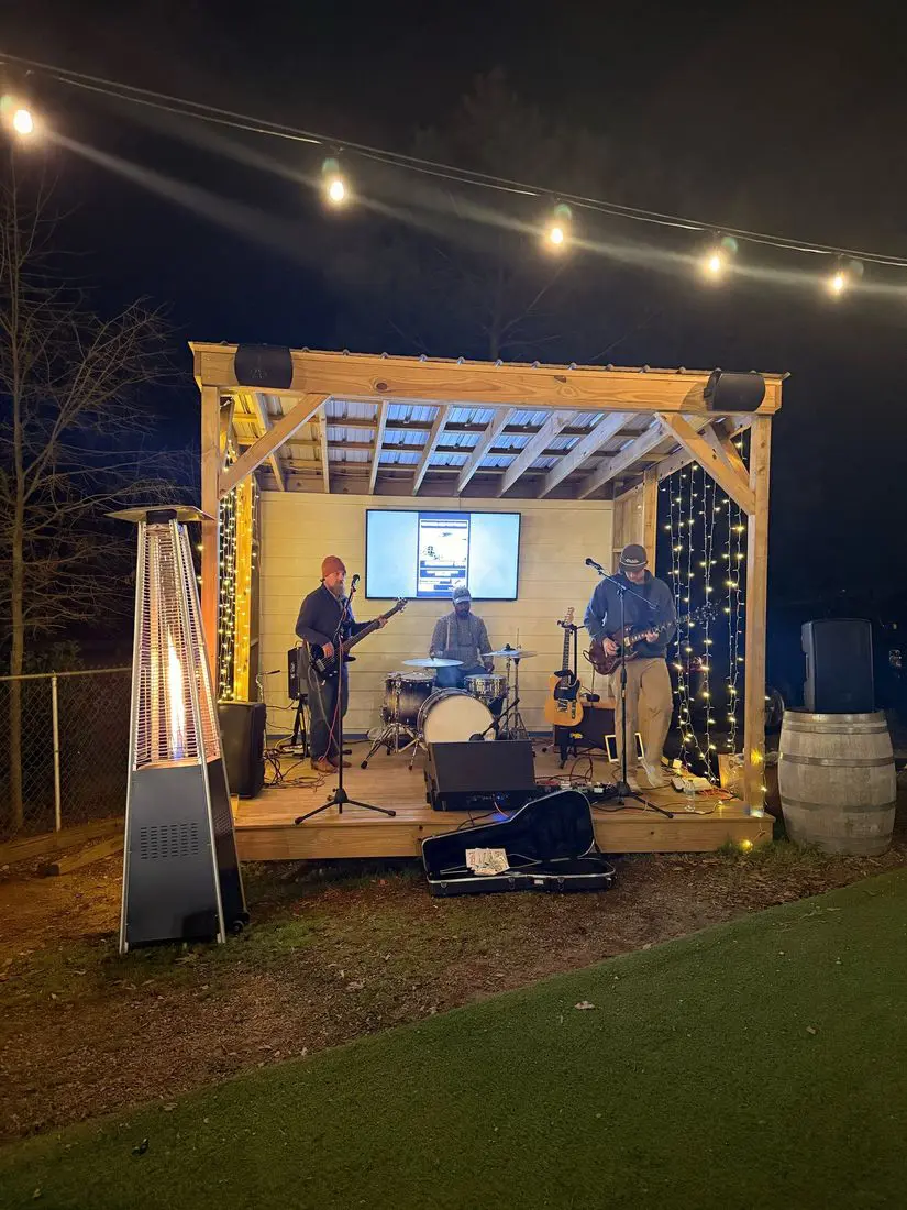 Live band playing the lit-up stage at night