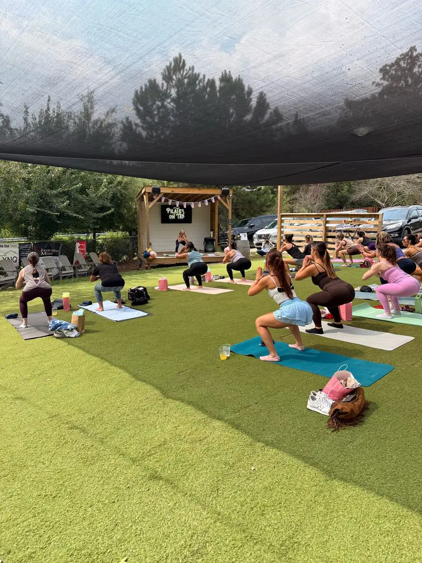 Pilates on Tap class under the shade sail