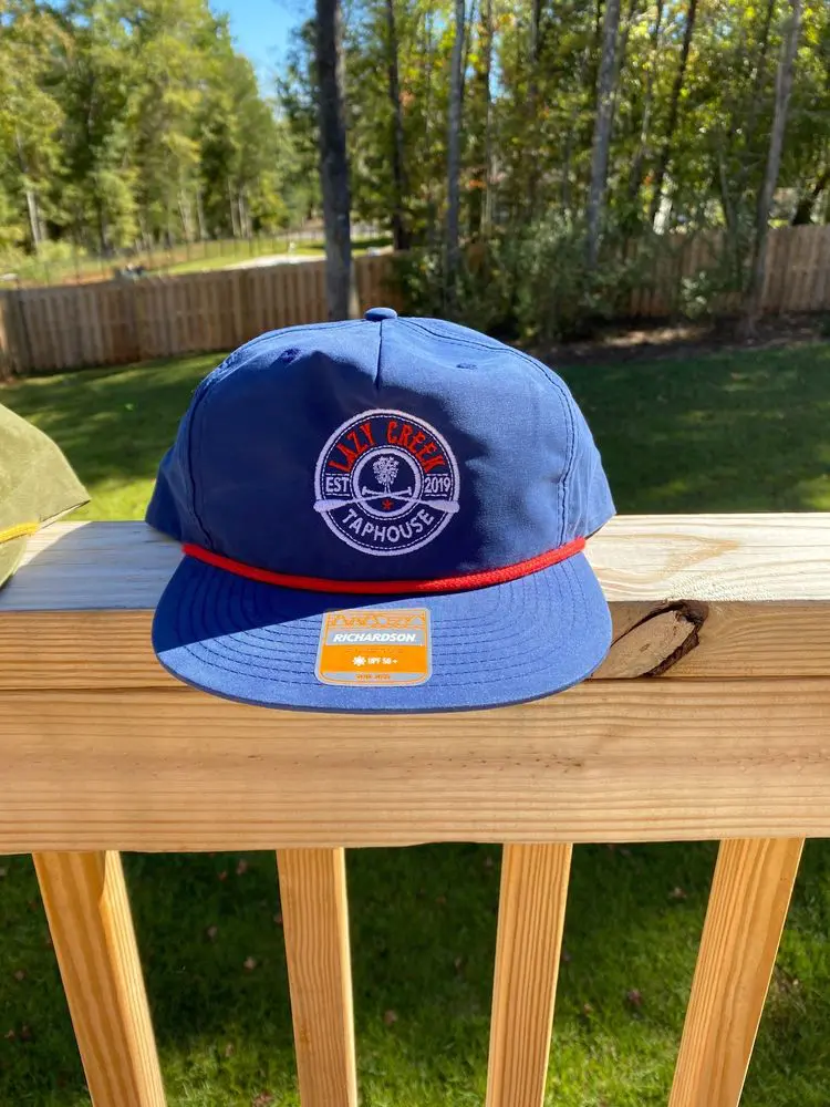Blue Lazy Creek rope hat on the porch rail
