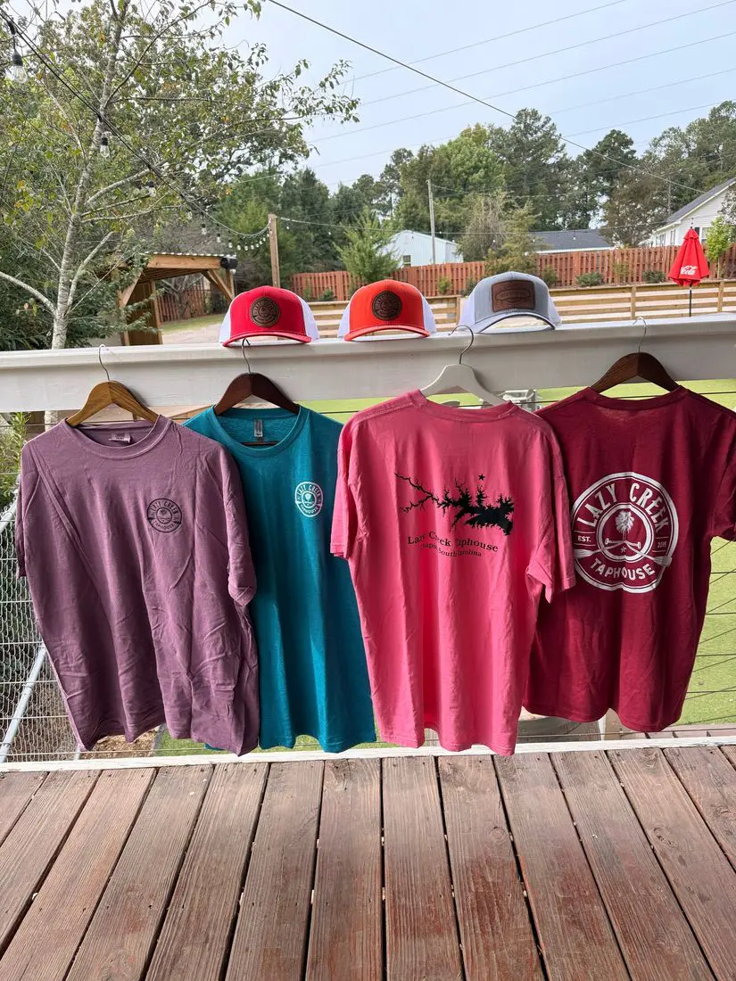Display of Lazy Creek t-shirts and hats