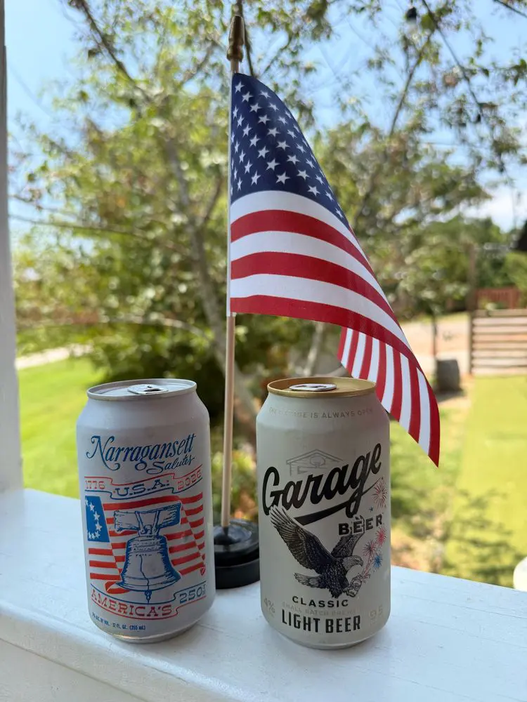 Garage and Narragansett cans in front of an American flag
