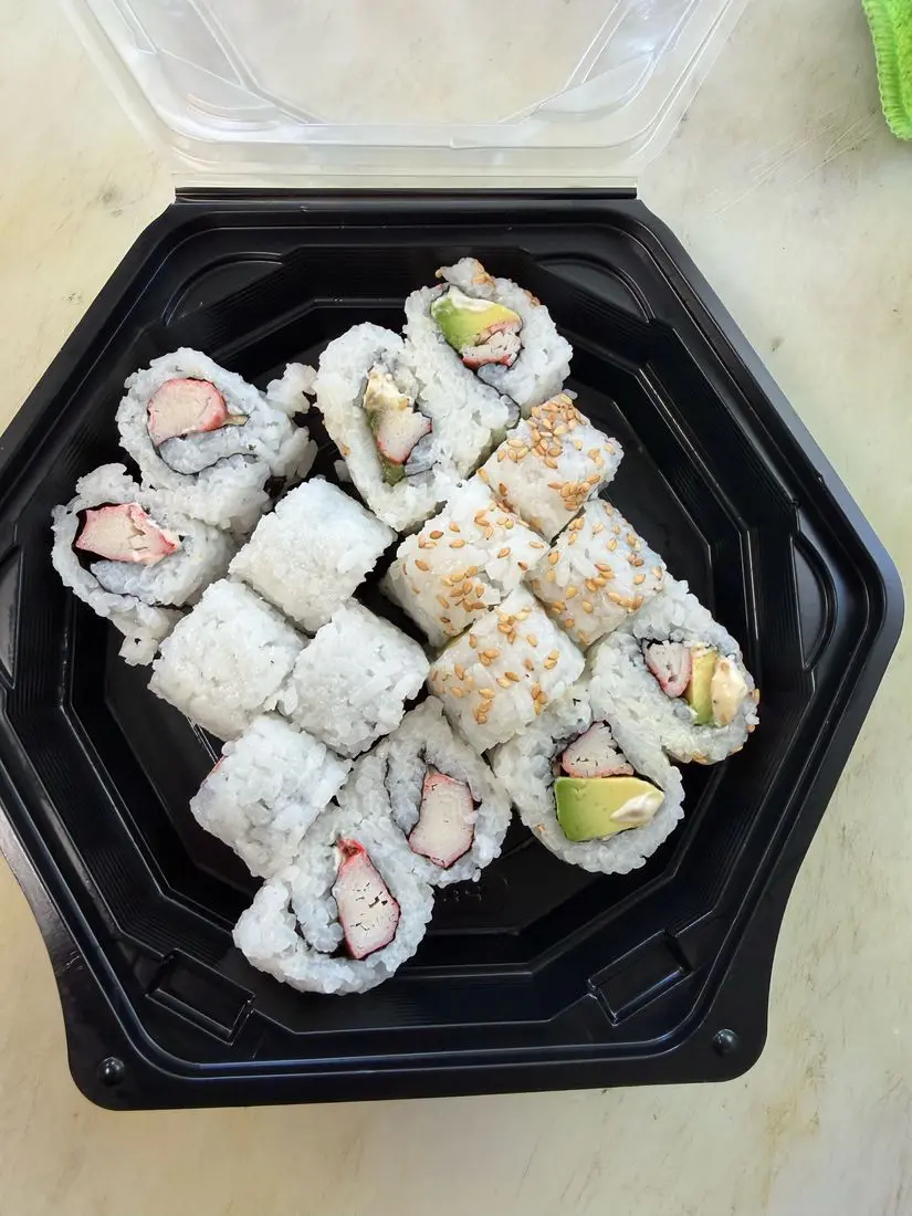 Tasty Teppanyaki sushi rolls in a to-go container