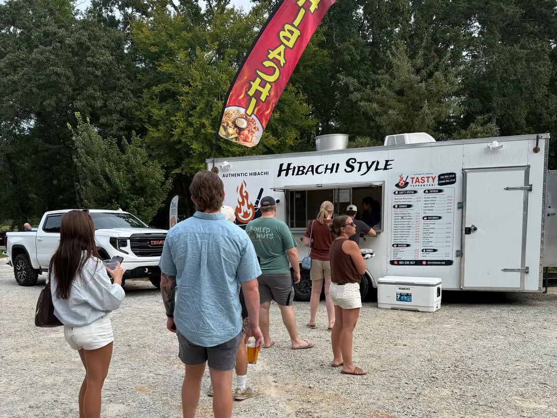 Tasty Teppanyaki hibachi truck at Lazy Creek with a line and a Hibachi flag